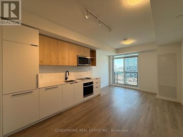 Toronto (Dovercourt-Wallace Emerson-Junction) condo for rent - A kitchen with white cabinets and a wooden countertop.