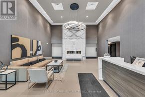 Milton (Walker) condo for rent - A modern living room with a white reception desk and a large abstract painting on the wall.