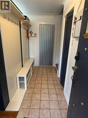 Windsor apartment for rent - A hallway with a bench and a door.