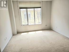 Toronto (Niagara) townhouse for rent - A room with a window and carpeted floor.