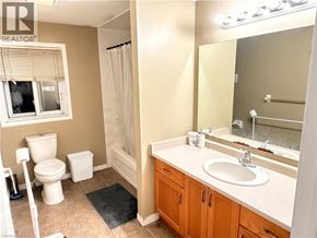 Kitchener apartment for rent - A bathroom with a toilet, sink, and shower.