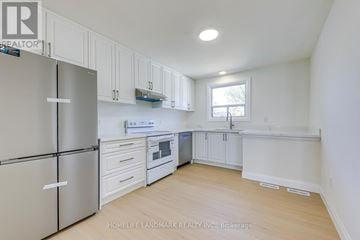 Oakville (Wo West) apartment for rent - A kitchen with white cabinets and a refrigerator.