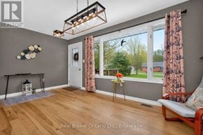 Tiny apartment for rent - A room with a fireplace and a chair.
