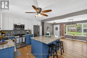 Tiny apartment for rent - A kitchen with blue cabinets and a marble island.