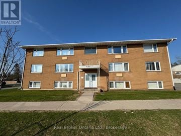 Orillia multi-family for rent - A building with the sign "Real Broker Ontario Ltd. Brokerage" in front of it.