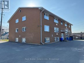 Orillia multi-family for rent - A building with the Real Broker Ontario Ltd. logo on it.