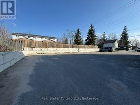Orillia multi-family for rent - A parking lot with a Real Broker Ontario Ltd. sign in Brokerage.