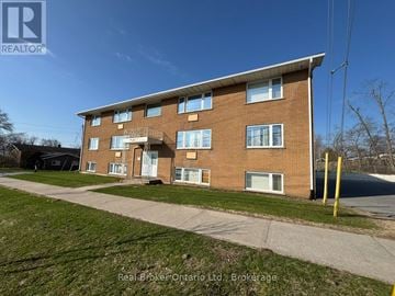 Orillia multi-family for rent - A building with a Real Broker Ontario logo on the side.