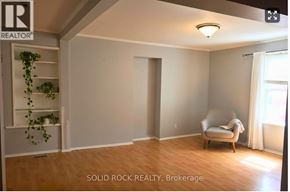 Arnprior apartment for rent - A room with a chair and a plant in it.
