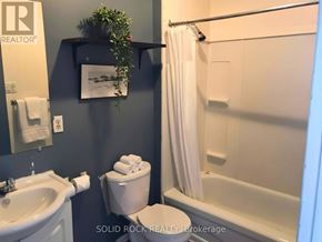 Arnprior apartment for rent - A bathroom with a toilet, sink, and bathtub.