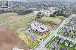 Clearview (Stayner) multi-family for rent - An aerial view of a real estate property with a large building and surrounding houses.
