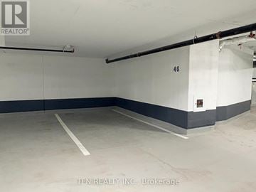 Burlington (Alton) condo for rent - A parking garage with the number 46 on the wall.