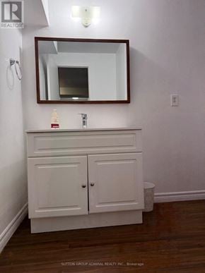 Barrie (Allandale) apartment for rent - A white bathroom vanity with a mirror above it.