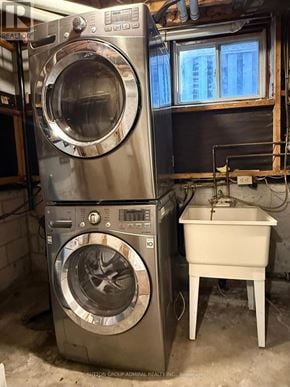 Barrie (Allandale) apartment for rent - A washing machine and dryer stacked on top of each other in a laundry room.