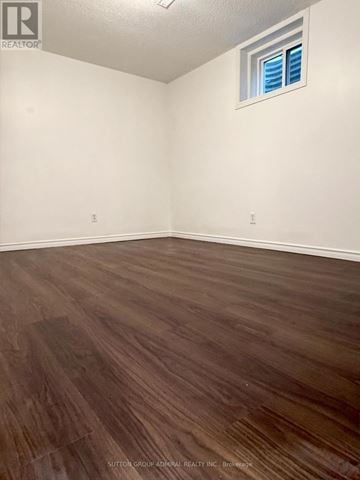 Barrie (Allandale) apartment for rent - A room with wooden flooring and a window with blinds.