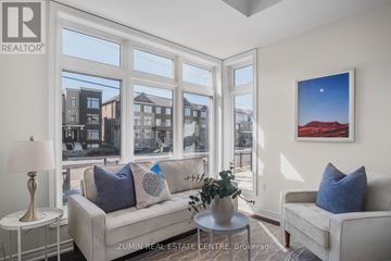 Oakville (Go Glenorchy) townhouse for rent - A living room with a couch, a table, and a painting on the wall.