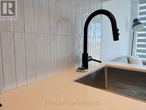Toronto (Centennial Scarborough) condo for rent - A kitchen sink with a black faucet and a white countertop.
