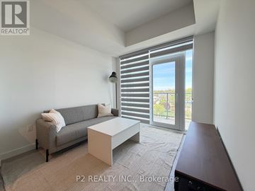 Toronto (Centennial Scarborough) condo for rent - A living room with a grey couch and a white coffee table.