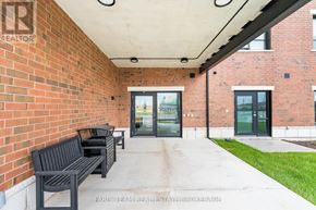 Clearview (Stayner) multi-family for rent - A brick building with a glass door entrance and a bench outside.
