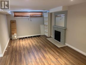 Mississauga (Cooksville) apartment for rent - A room with a fireplace and wooden flooring.