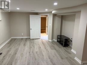 Mississauga (Cooksville) apartment for rent - A spacious room with a white door and a black table.