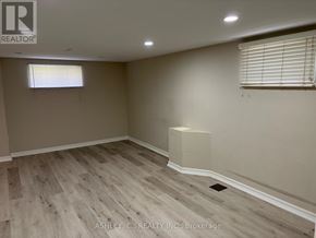 Mississauga (Cooksville) apartment for rent - A room with wooden flooring and a window with blinds.