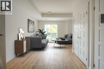 Kitchener condo for rent - A living room with a grey couch and a black coffee table.