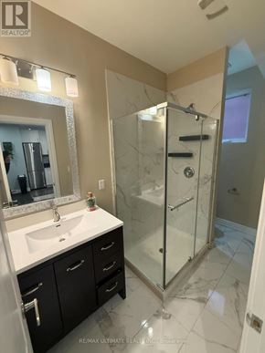 Toronto (Yorkdale-Glen Park) apartment for rent - A bathroom with a sink, mirror, and shower.