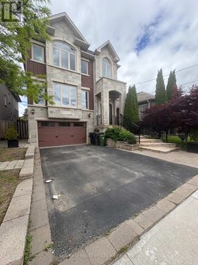 Toronto (Yorkdale-Glen Park) apartment for rent - A large house with a driveway in front.