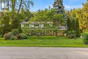 Oakville (Sw Southwest) apartment for rent - A house with a lawn and trees in front of it.