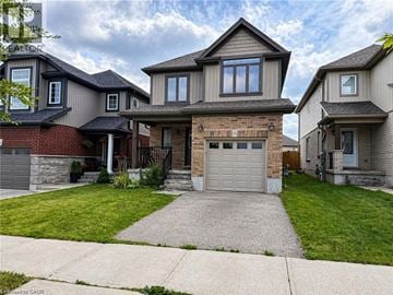 Kitchener apartment for rent - A house with a garage in front of it.