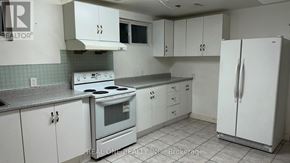 Mississauga (Mississauga Valleys) apartment for rent - A kitchen with white cabinets and a stove top oven.
