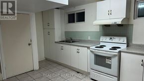 Mississauga (Mississauga Valleys) apartment for rent - A white kitchen with a stove, sink, and cabinets.