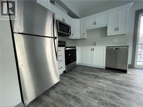 Simcoe apartment for rent - A kitchen with a refrigerator, microwave, oven, and dishwasher.