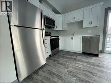 Simcoe apartment for rent - A kitchen with a refrigerator, microwave, oven, and dishwasher.