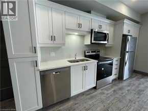 Simcoe apartment for rent - A kitchen with white cabinets and stainless steel appliances.