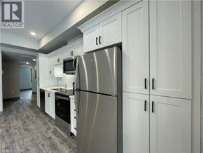 Simcoe apartment for rent - A modern kitchen with a stainless steel refrigerator and white cabinets.