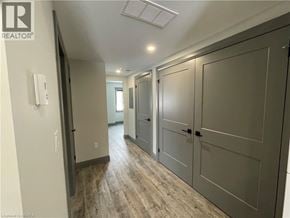Simcoe apartment for rent - A hallway with a white door on the left and a grey door on the right.