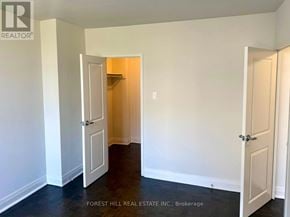 Toronto (Don Valley Village) house for rent - A room with two doors, one of which is open, and a sign that says "REALTOR".