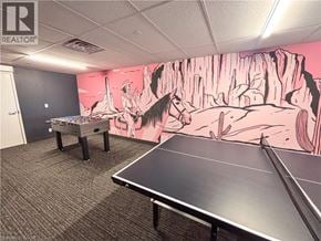 Kitchener condo for rent - A room with a pink wall and a large mural of a cowboy scene.