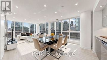 Toronto (Waterfront Communities) condo for rent - A modern living room with a glass table and chairs.