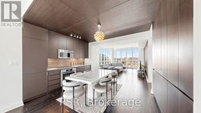 Toronto (Waterfront Communities) condo for rent - A modern kitchen with a dining area and a balcony.