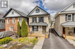 Newmarket (Central Newmarket) apartment for rent - A real estate photo of a house with a driveway and a small tree in front.