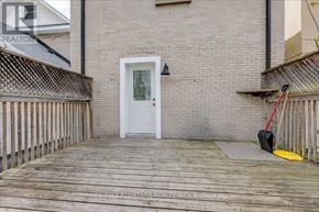 Newmarket (Central Newmarket) apartment for rent - A white door is on the left side of a brick building.