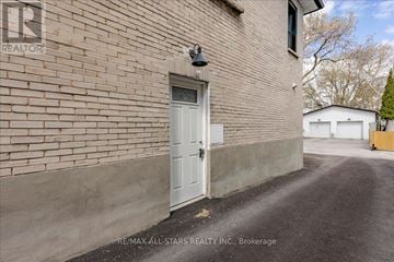 Newmarket (Central Newmarket) apartment for rent - A white door is on the side of a brick building.
