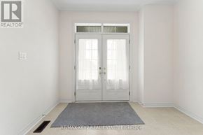 Richmond Hill apartment for rent - A white door with a glass window is in the middle of a room with a grey rug on the floor.