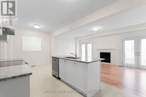 Richmond Hill apartment for rent - A spacious kitchen with white cabinets and a marble countertop.