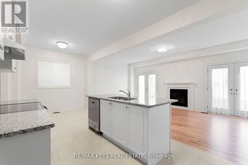 Richmond Hill apartment for rent - A spacious kitchen with white cabinets and a marble countertop.