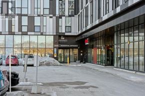 Oshawa (Samac) condo for rent - A parking lot in front of a building with a sign that says "Residential Entrance".
