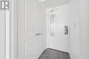 Oshawa (Samac) condo for rent - A white door with a glass window is in the hallway.